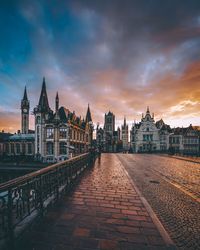 Buildings in city at sunset