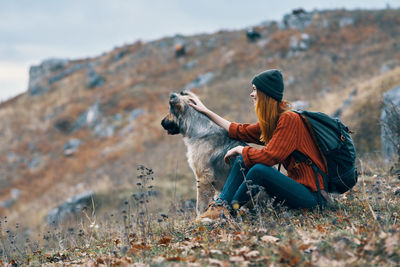 Dog sitting on rock