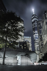 Low angle view of illuminated buildings against sky at night