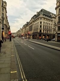 View of city street and buildings against sky