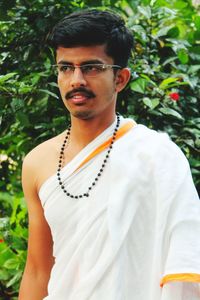 Portrait of young man wearing sunglasses standing outdoors