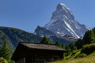 Scenic view of snowcapped mountains against clear sky