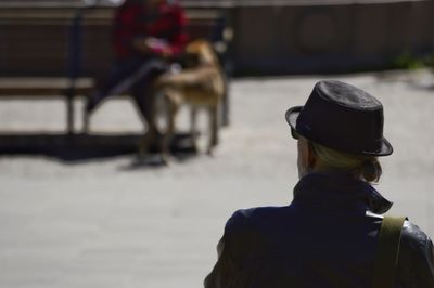 Rear view of man sitting on bench 