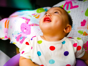 Close-up of cute baby girl drooling at home