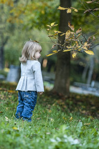 Boy standing in grass