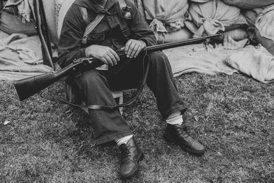 Low section of man sitting on field