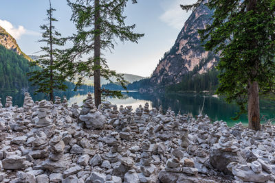 Scenic view of rocks by lake against sky