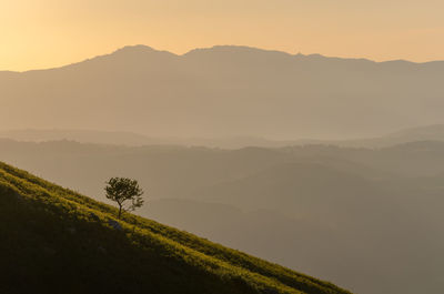 Scenic view of mountains against sky during sunset