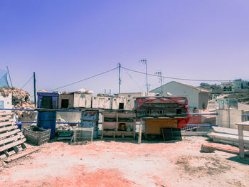 Houses and buildings against clear blue sky