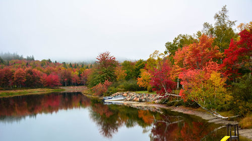 Reflection of trees in lake against sky during autumn