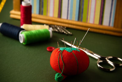 Close-up of hand holding multi colored candies on table