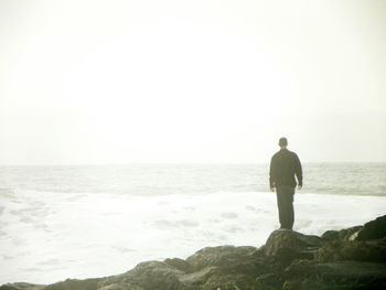 Silhouette of woman standing on beach