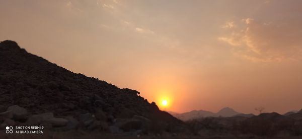 Scenic view of mountains against sky during sunset