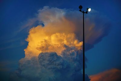 Low angle view of street light against sky at sunset