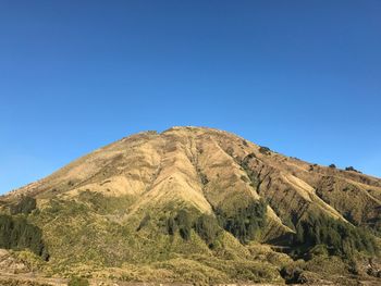 Scenic view of mountain against clear blue sky