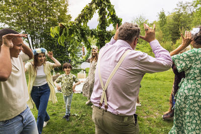 People dancing around midsummer maypole