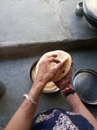 Cropped image of woman holding chapattis