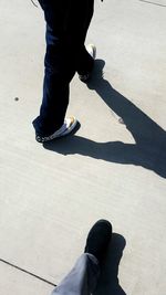 Low section of woman standing on road