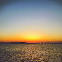 Scenic view of sea against clear sky during sunset