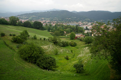 High angle view of townscape and trees on field