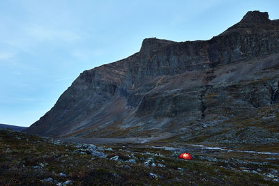 Illuminated tent in mountains