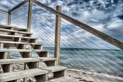 Low angle view of bridge over sea against sky