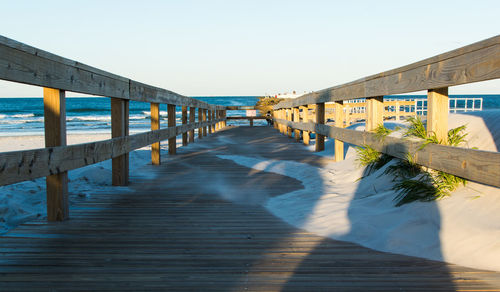 Pier over sea against clear sky