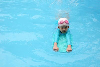 High angle view of girl swimming in pool