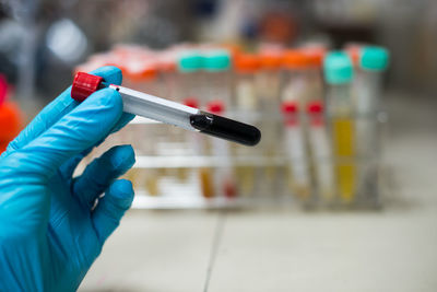 Cropped hand holding test tube in laboratory