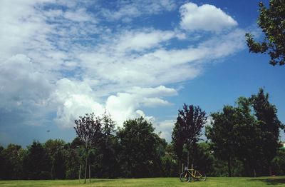 Scenic view of grassy field against cloudy sky