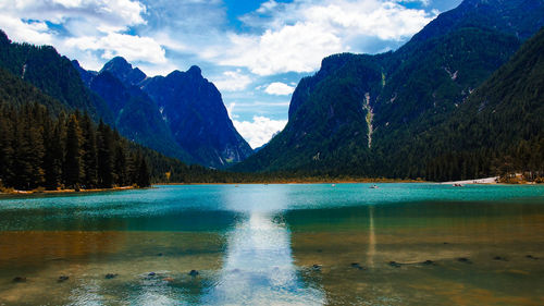 Scenic view of lake and mountains against sky