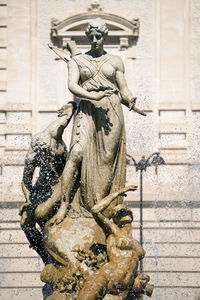 Statue of fountain against building