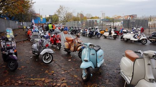 Motor scooters parked on road