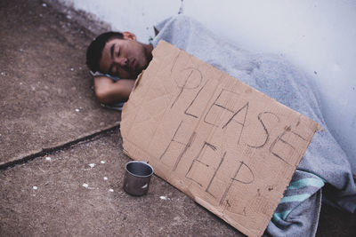 High angle view of man lying down on floor