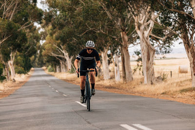 Full length of woman riding bicycle