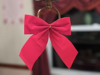 Close-up of red decoration hanging on paper