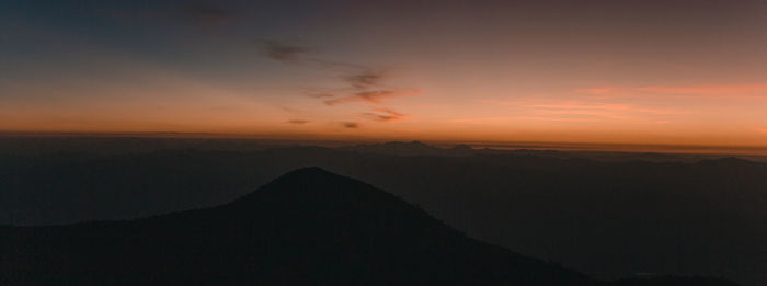 Scenic view of silhouette mountain against sky during sunset