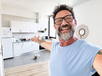 Portrait of young man standing at home