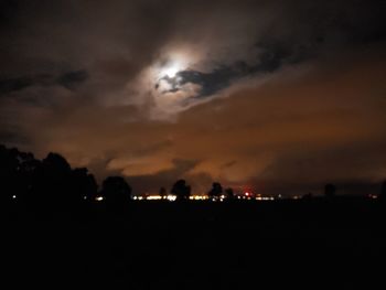 Illuminated city against sky at night