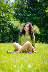 Young woman sitting on grass