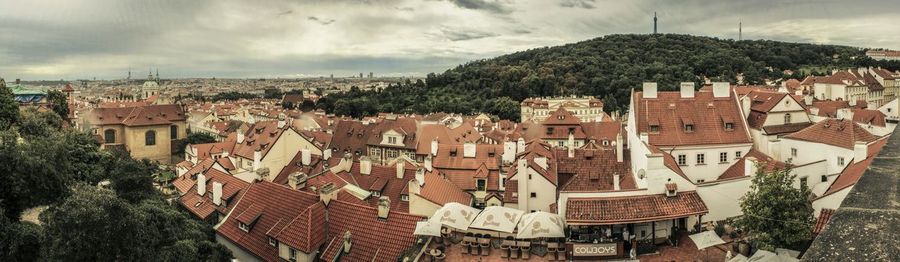 High angle shot of townscape against cloudy sky