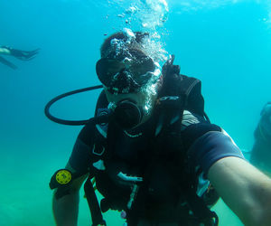 Midsection of man swimming in sea