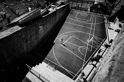 High angle view of boy playing basket ball at court