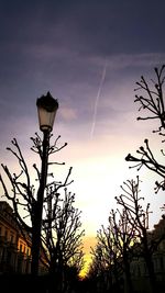 Low angle view of silhouette trees against dramatic sky