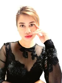 Portrait of young woman against white background