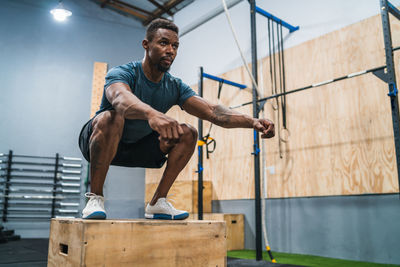 Full length of man exercising in gym