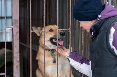 Girl volunteer in the nursery for dogs. shelter for stray dogs.