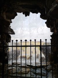 Scenic view of historic building seen through fence