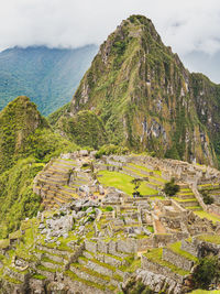 High angle view of ruins of mountain against cloudy sky