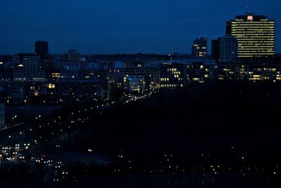 Illuminated cityscape against sky at night